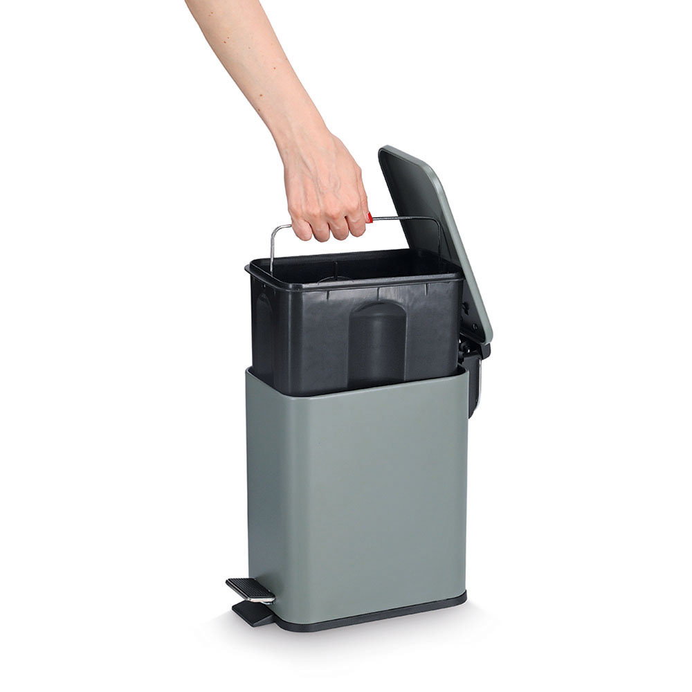 Salbeigrüner Treteimer mit geöffnetem Deckel und Inneneimer Offener Mülleimer in Salbeigrün mit Fußpedal  eine Hand hebt den schwarzen Inneneimer heraus, seitlich aufgenommen