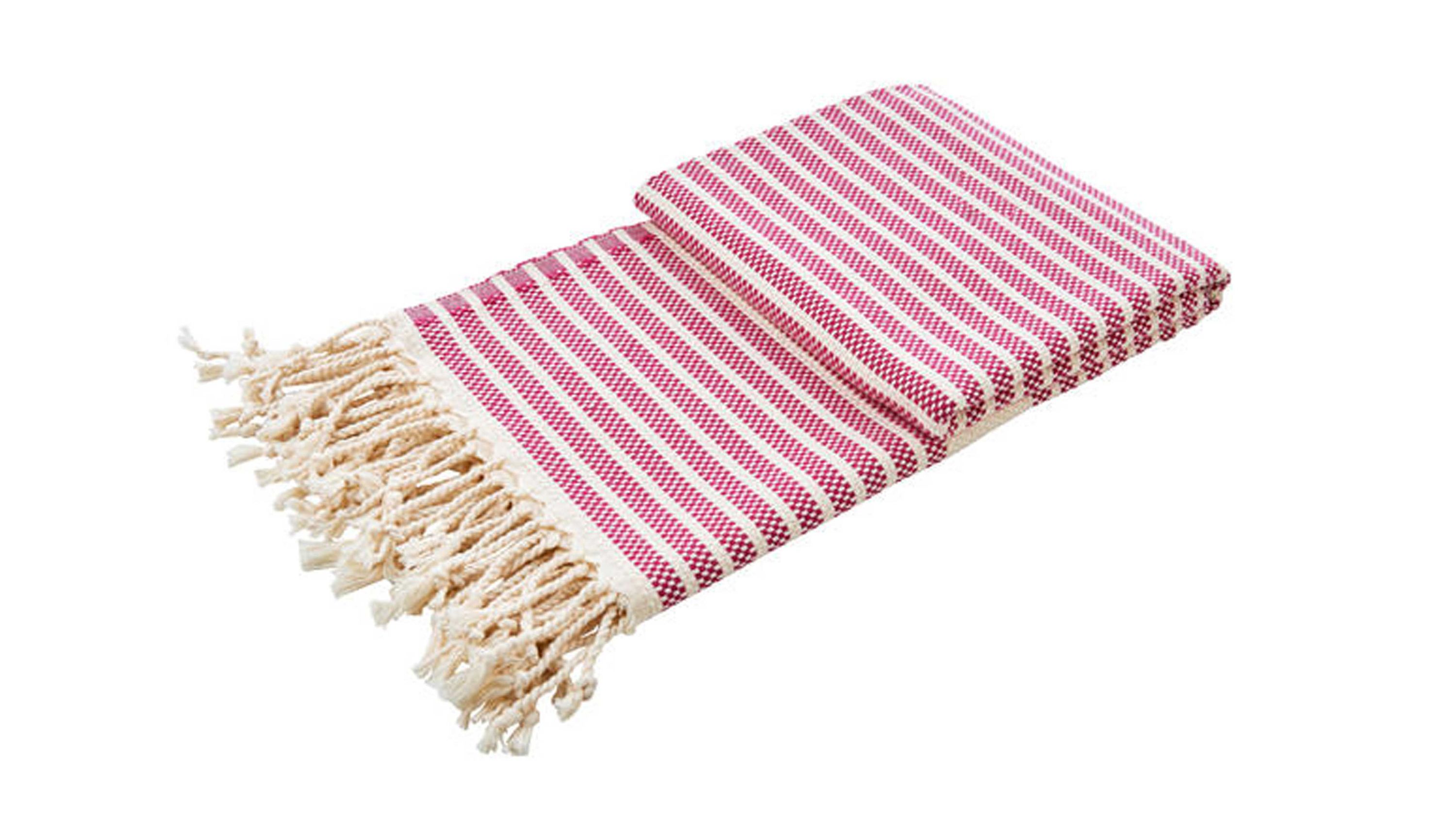 Gefaltete Wohndecke mit pinken und weißen Streifen und Fransen an einer Seite
