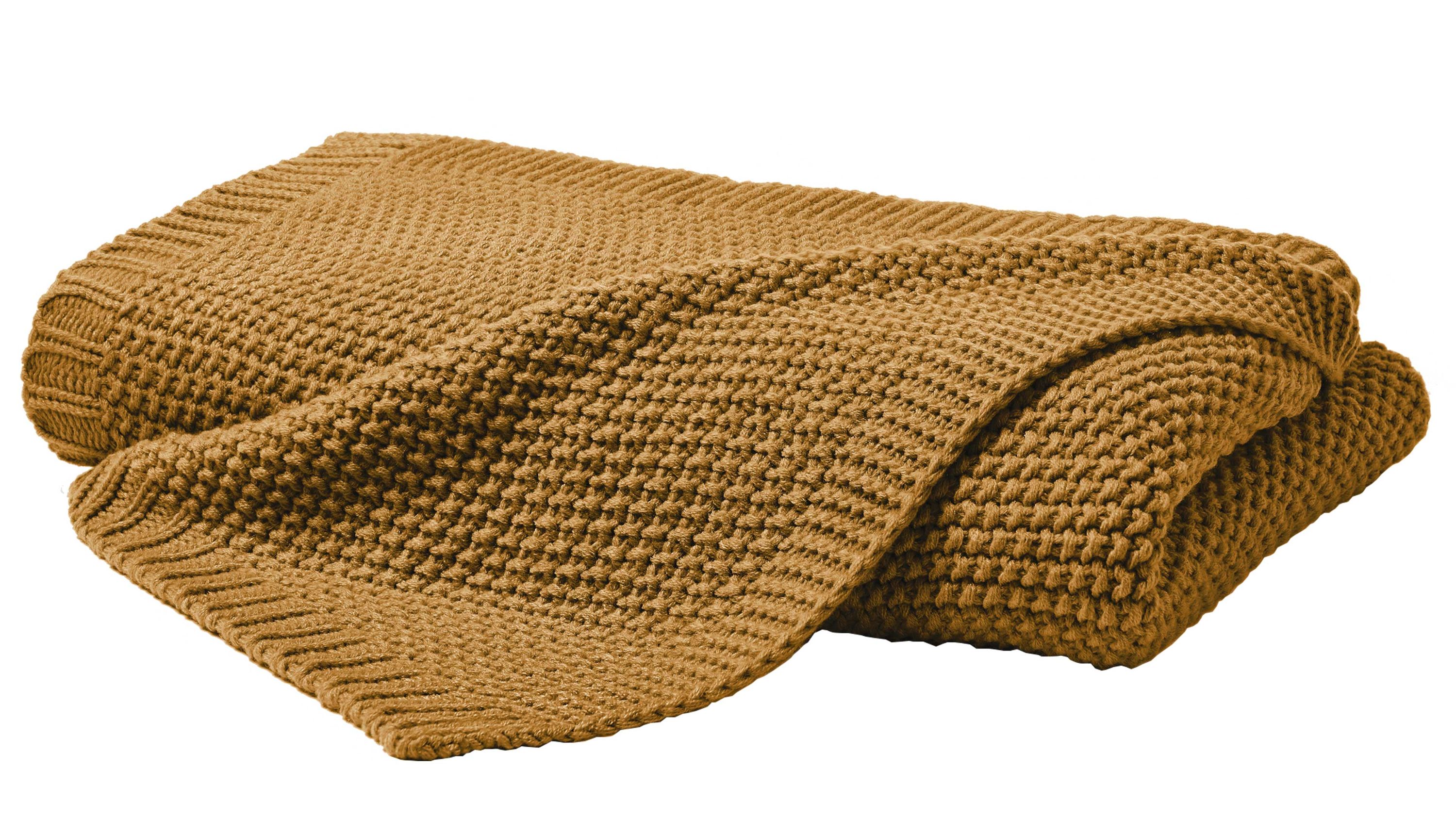 Gefaltete senffarbene Strickdecke mit grobem Muster
