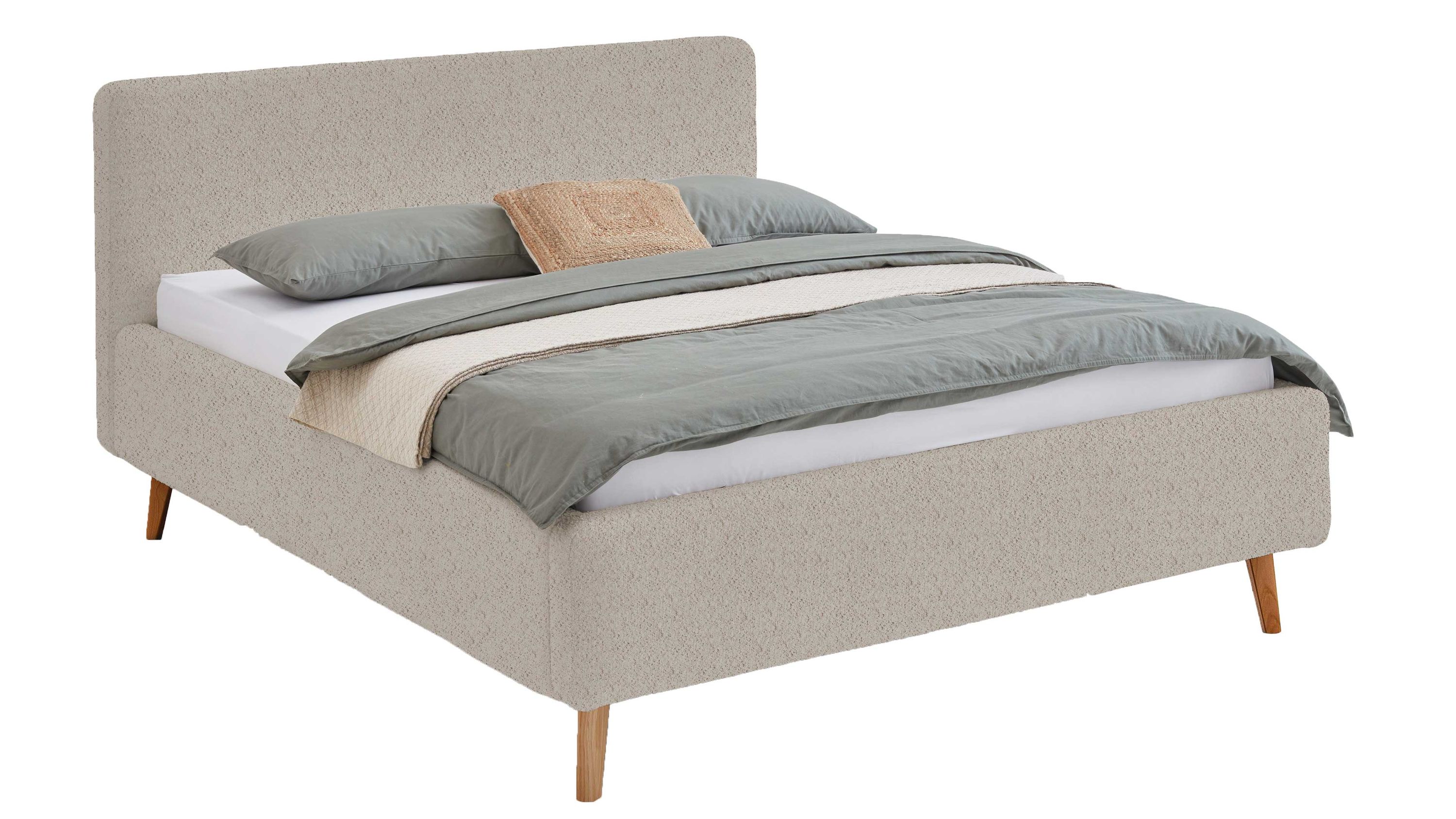 Polsterbett mit hohem Kopfteil und Holzfüßen in Beige Beigefarbenes Polsterbett mit hohem Kopfteil und Holzfüßen mit Bettdecke und Kissen belegt