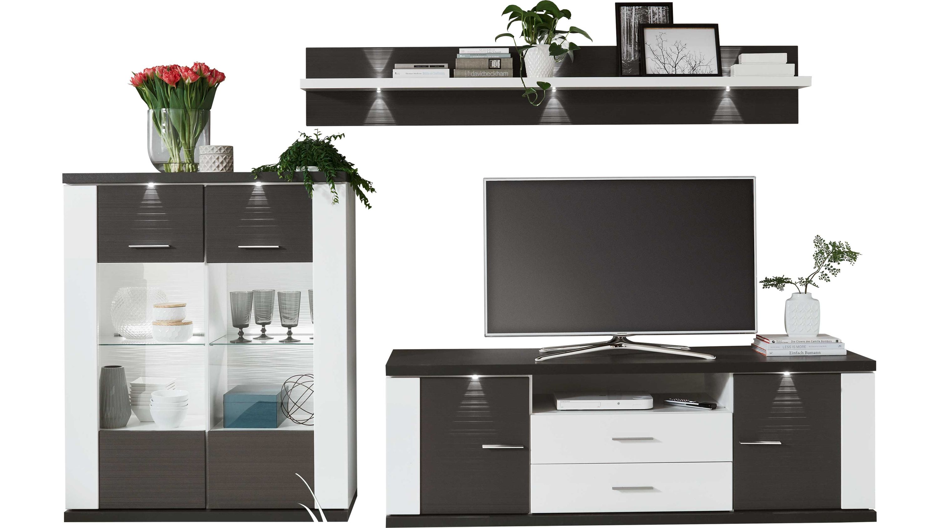 Dreiteilige Wohnwand in Weiß und Graphit Dreiteilige Wohnwand mit weißen und graphitfarbenen Elementen bestehend aus Vitrine TV-Board und Wandregal mit Beleuchtung