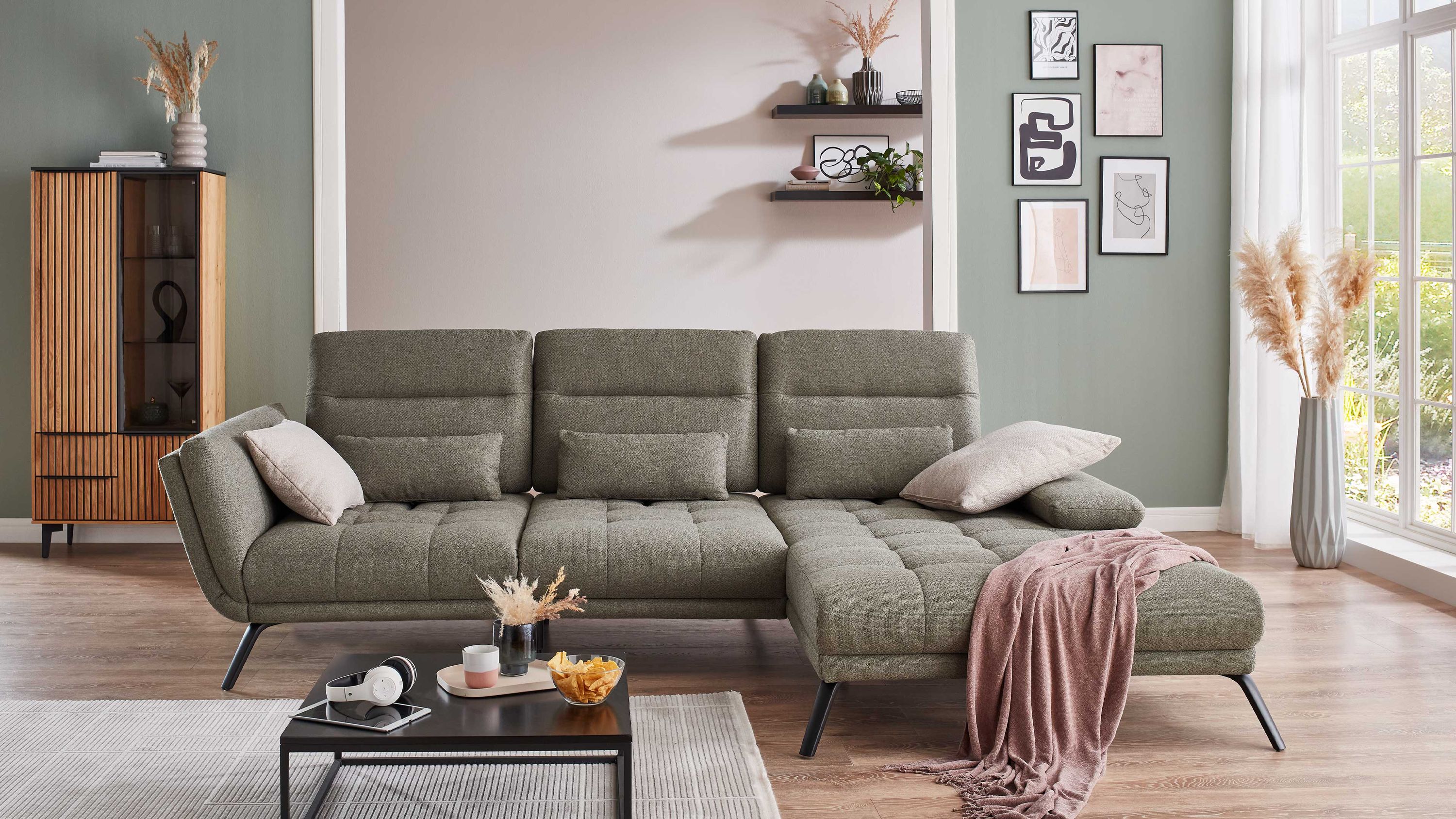 Ecksofa mit olivfarbenem Flachgewebe schwarzen Metallfüßen drei Rückenlehnen und zwei Kissen