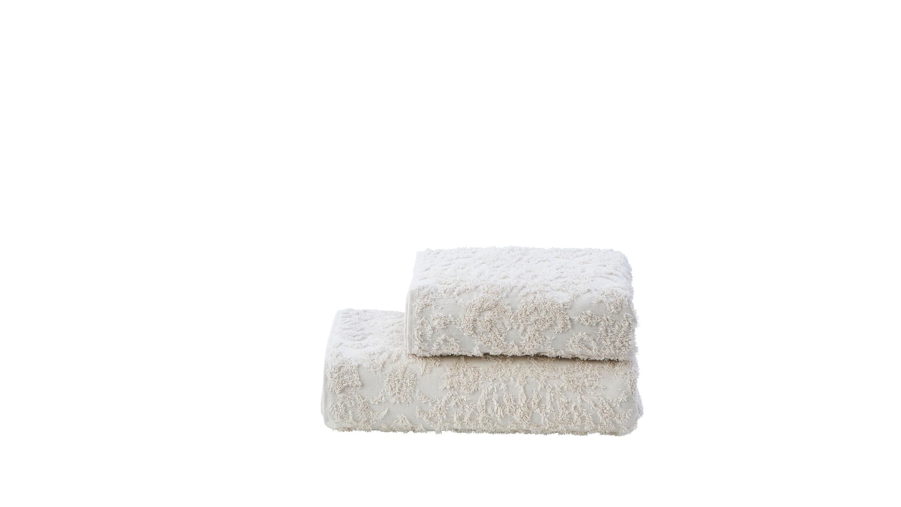 Zwei beige Handtücher mit Ornamentmuster übereinandergelegt