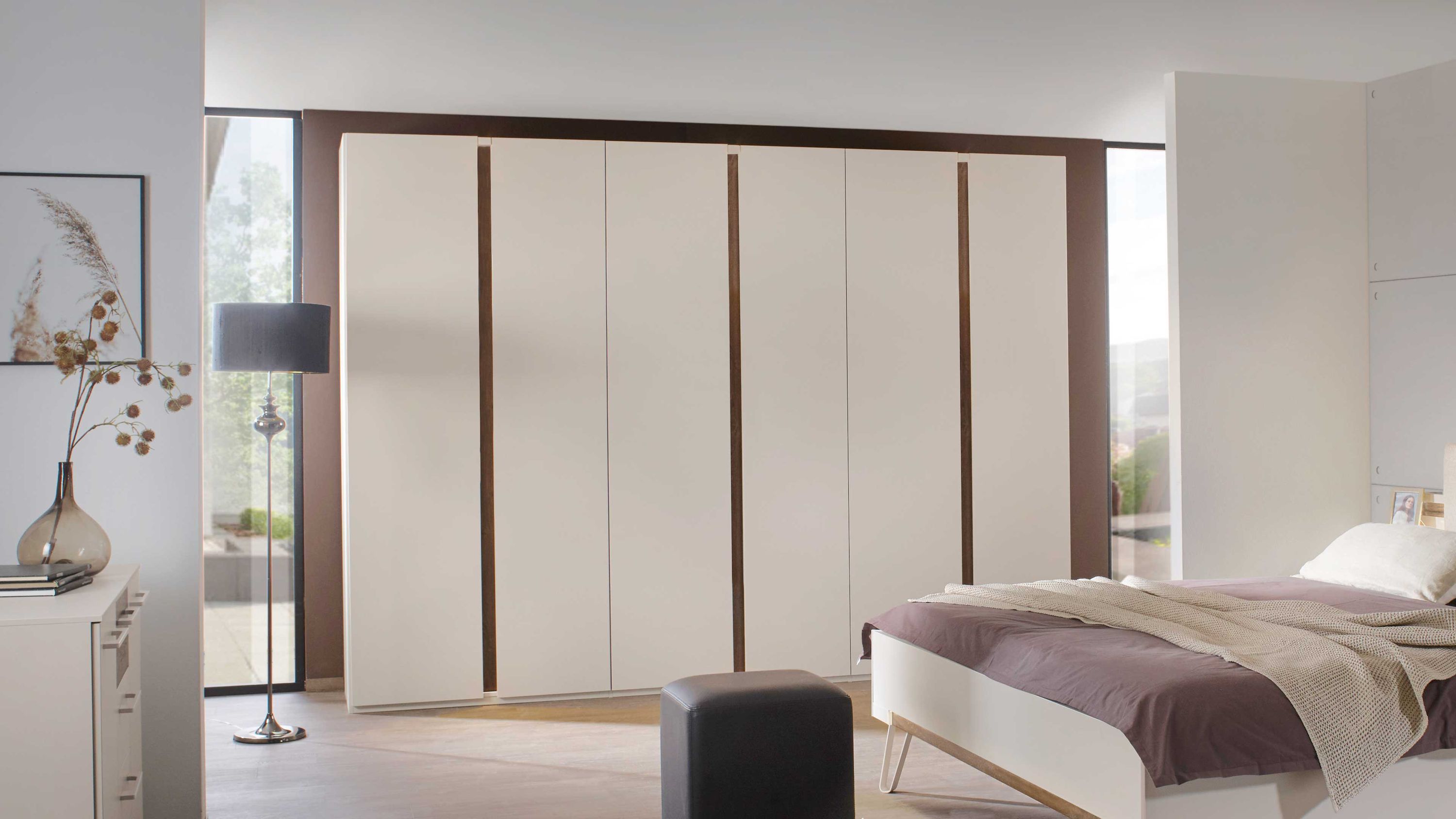 Sechs-türiger Kleiderschrank in champagnerfarben mit dunklen Akzenten in einem Schlafzimmer