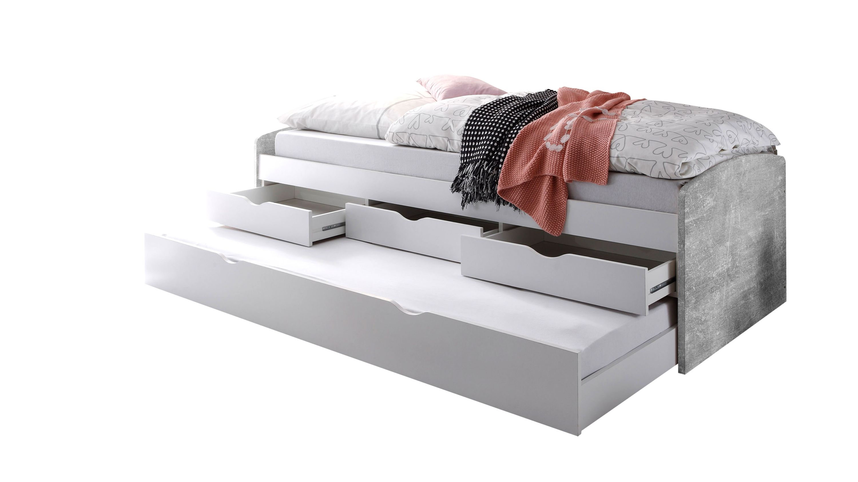 Funktionsbett mit betonfarbener Rückwand und weißen Schubladen drei offene Schubladen und ausziehbare Liegefläche