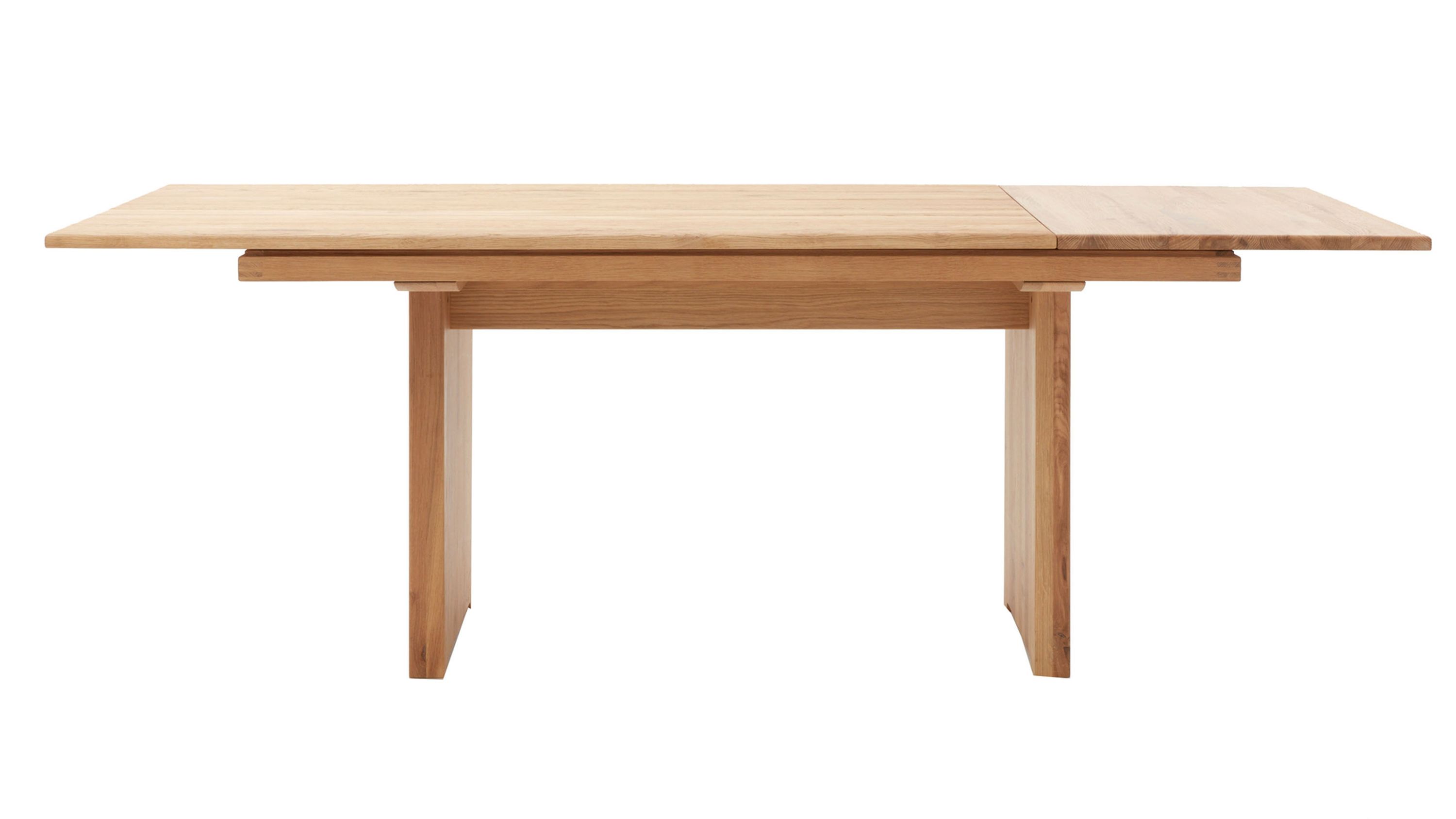 Ausziehtisch aus hellem Holz mit rechteckiger Tischplatte und zwei breiten Beinen