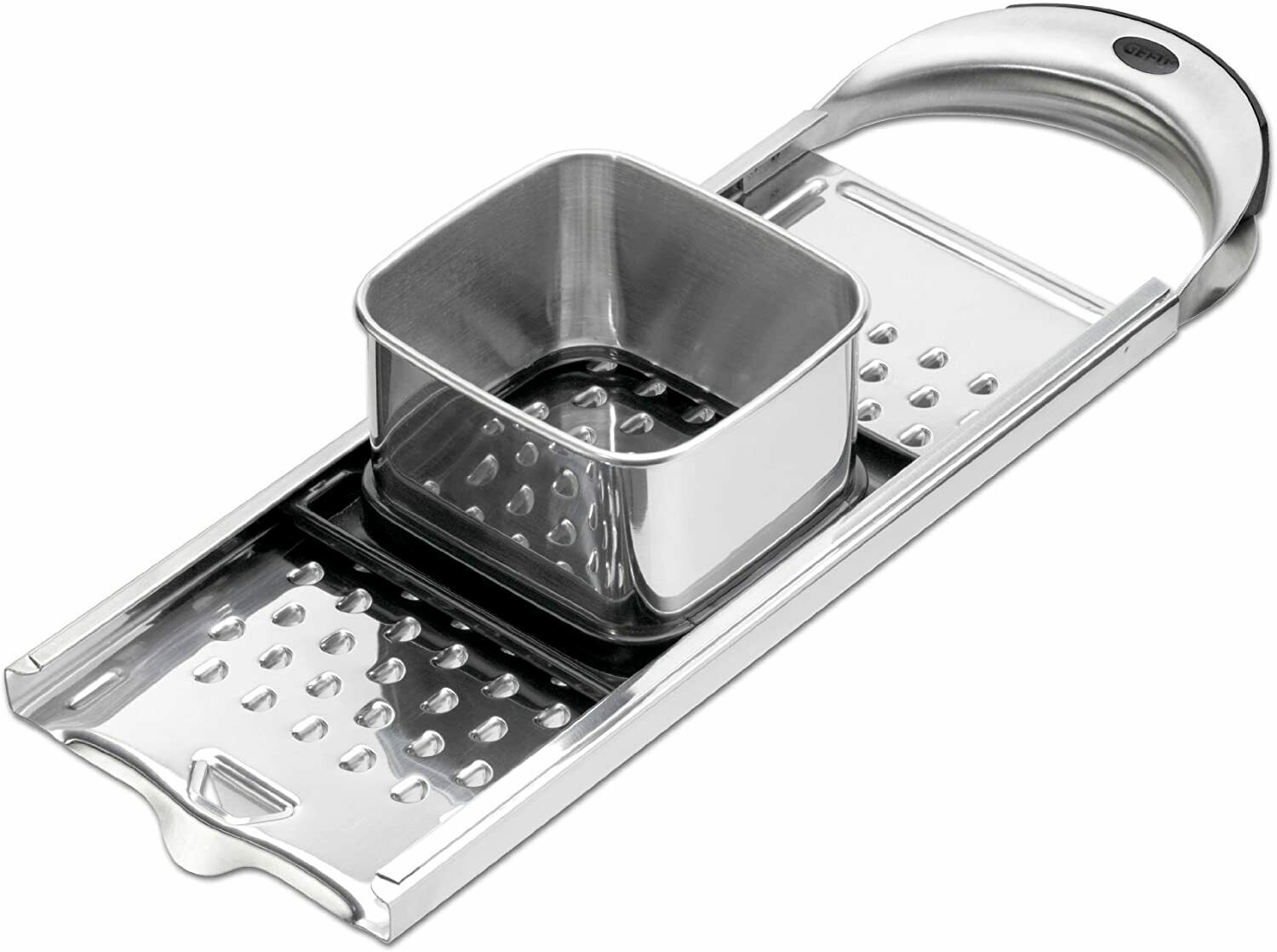 Edelstahl-Hobel Edelstahl-Hobel mit quadratischem Behälter und geriffelter Reibe, liegend auf flacher Oberfläche.