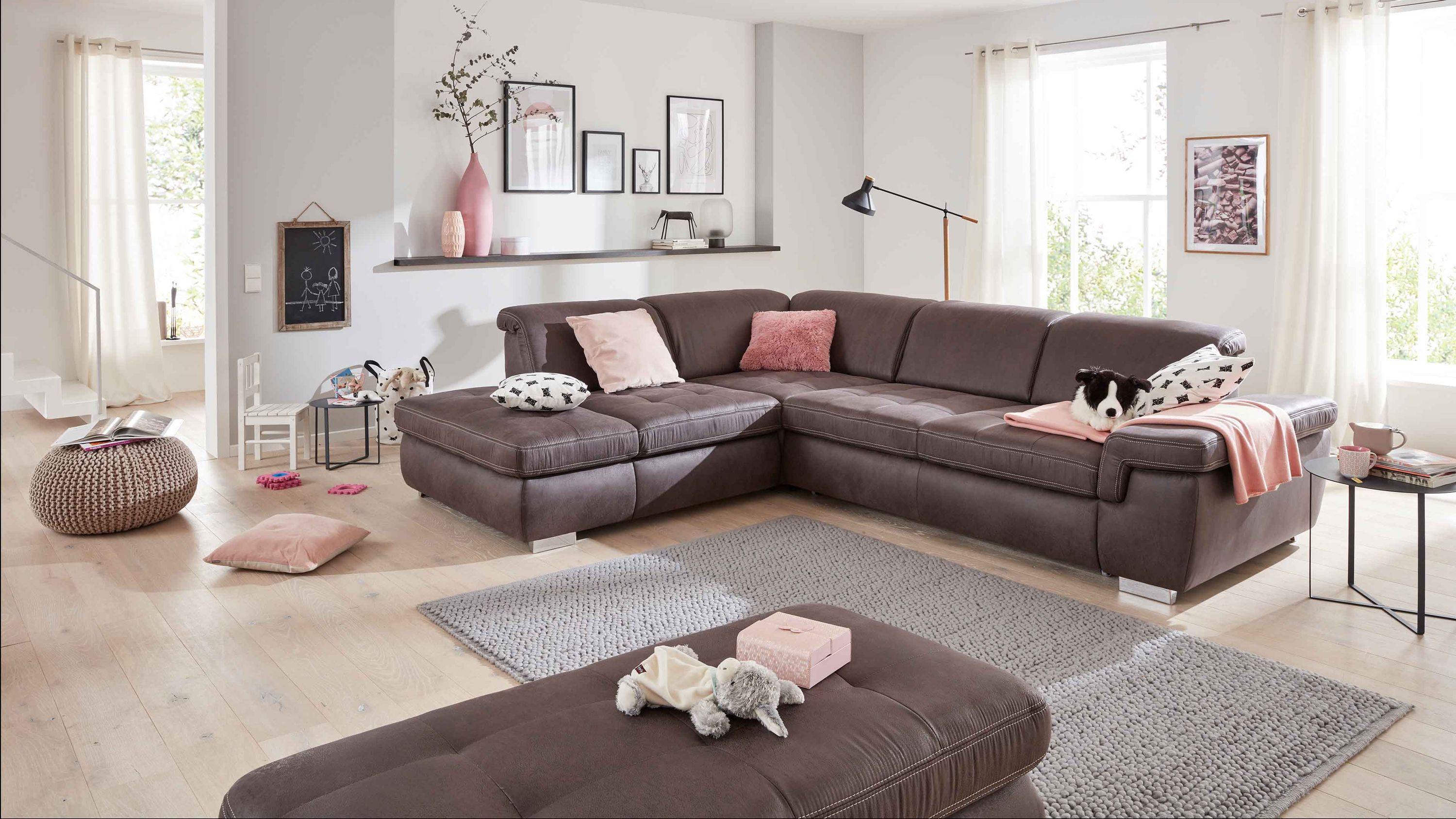 Anthrazitfarbenes Ecksofa mit Mikrofaserbezug und glänzenden Metallfüßen in hellem Wohnzimmer