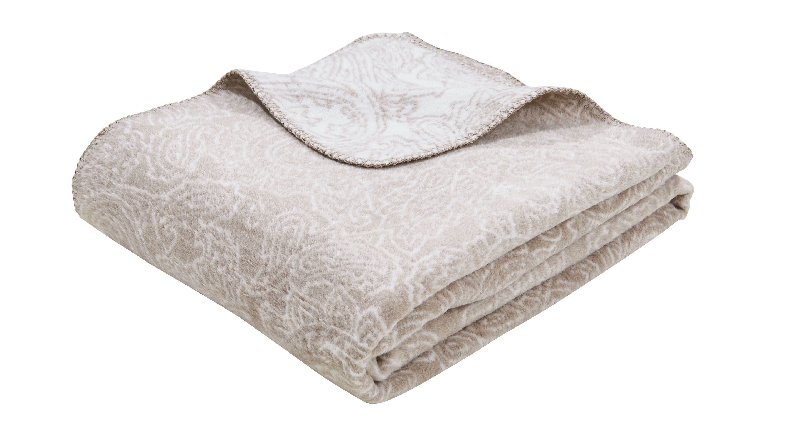Gefaltete Wohndecke mit floralem Muster in Beige und Weiß