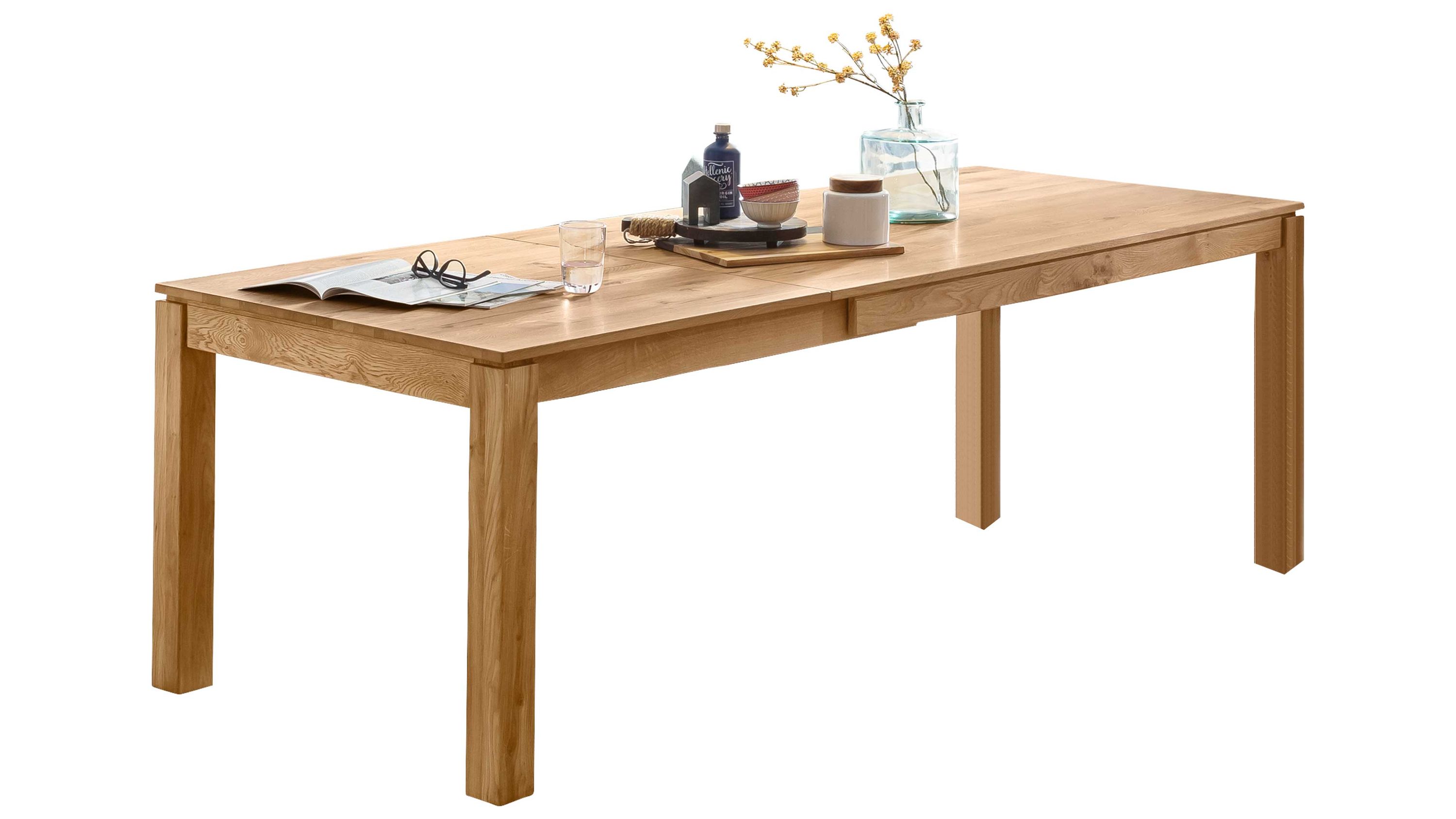 Ausziehtisch in rechteckiger Form aus hellem Holz Rechteckiger ausziehbarer Tisch mit vier Beinen in hellbrauner Holzoptik mit Dekoration