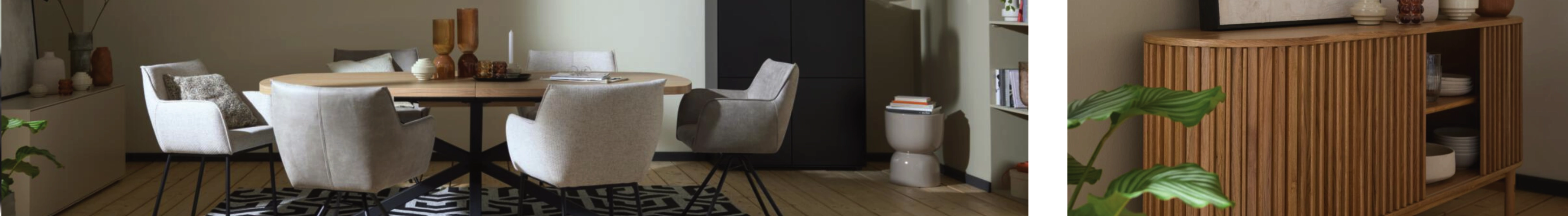 Modernes Esszimmer mit rundem Holztisch, weißen Stühlen und schwarzem Teppich mit geometrischem Muster.