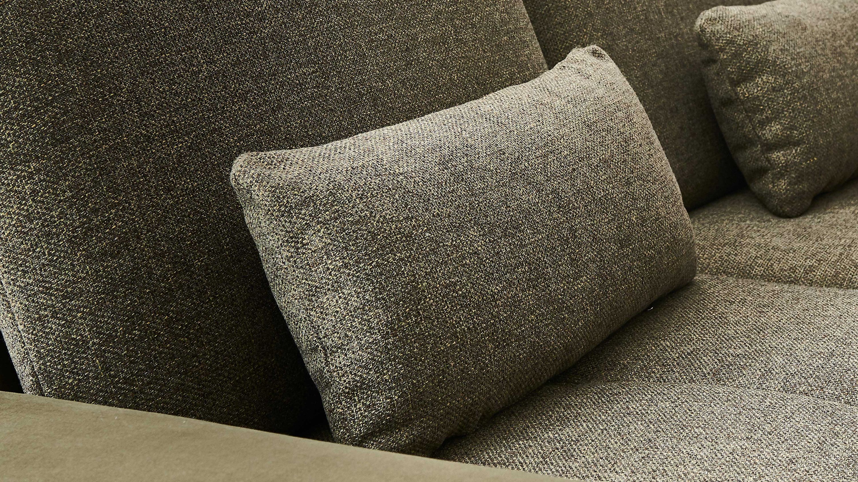 Rechteckiges Kissen in Oliv auf einem dunkelgrünen Sofa mit Strukturstoff