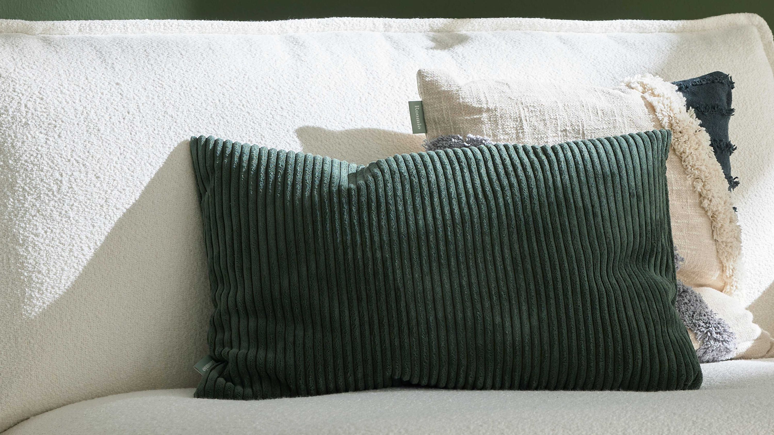 Rechteckiges Kissen mit breiten vertikalen Cordstreifen in dunklem Grün auf hellem Sofa
