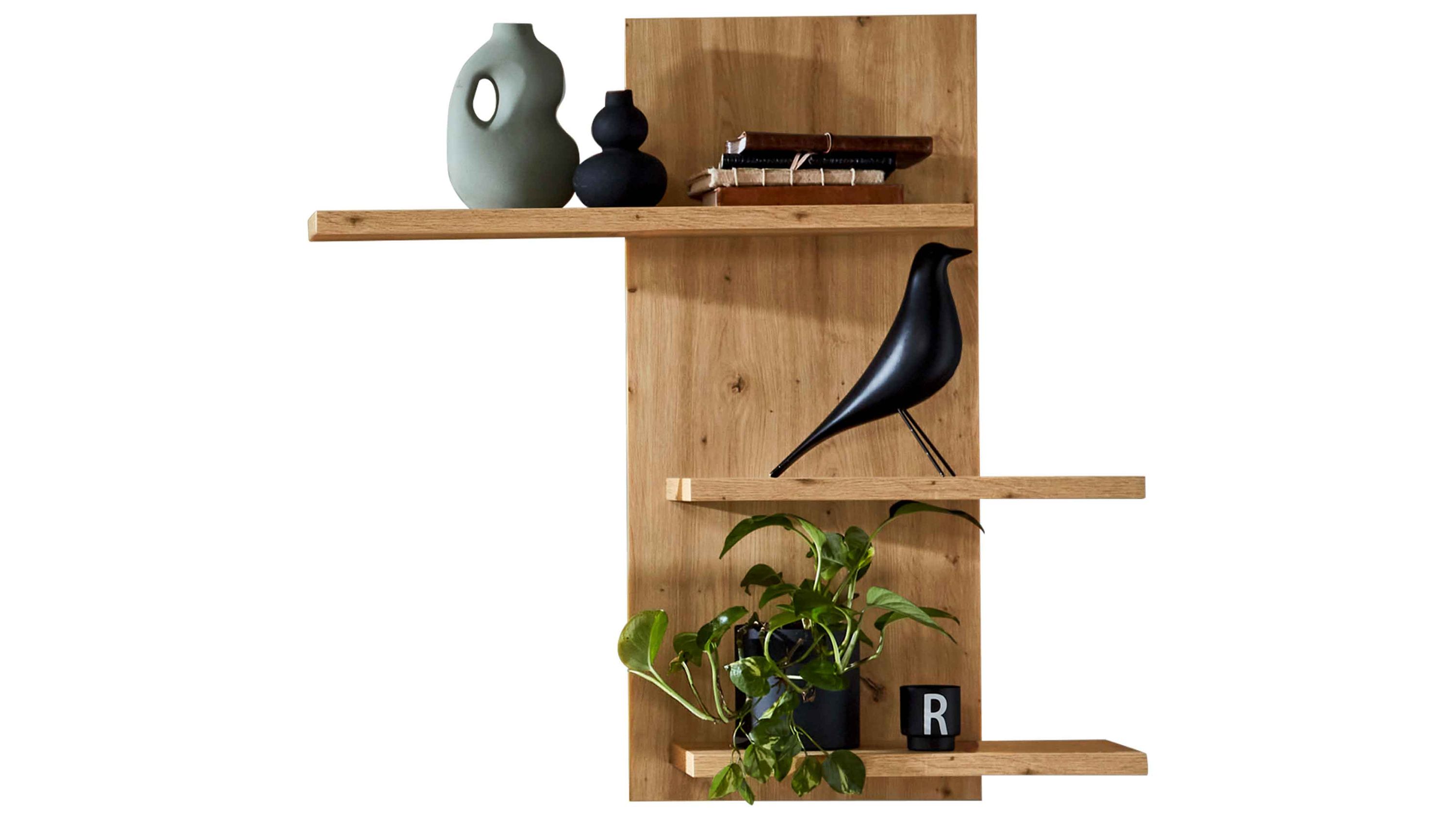 Wandboard aus hellem Holz mit drei Regalböden dekoriert mit Vasen Büchern Vogelfigur und grüner Pflanze