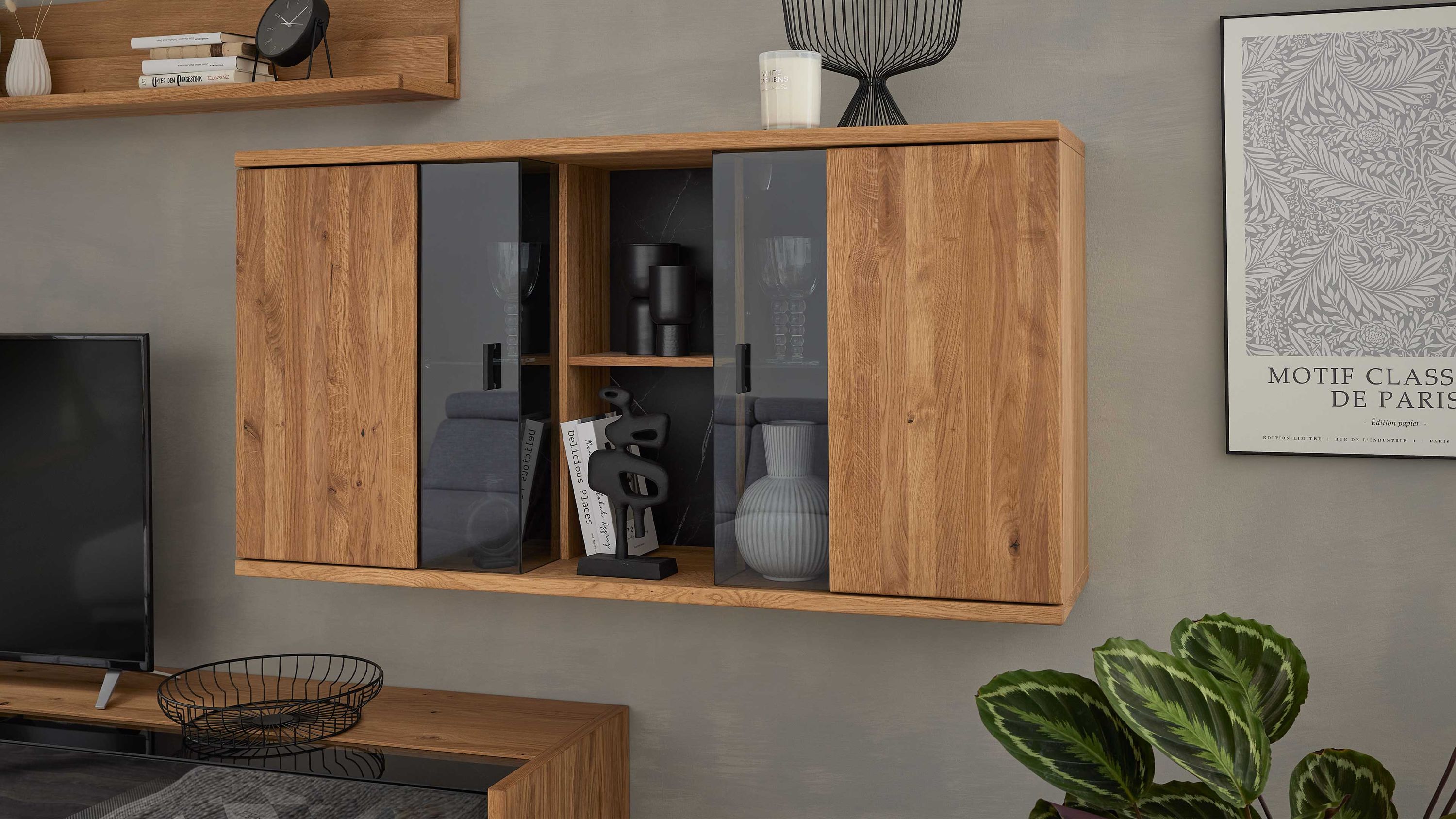 Hängeschrank mit zwei Holztüren und zwei Glastüren in Holzoptik an grauer Wand mit Dekoration