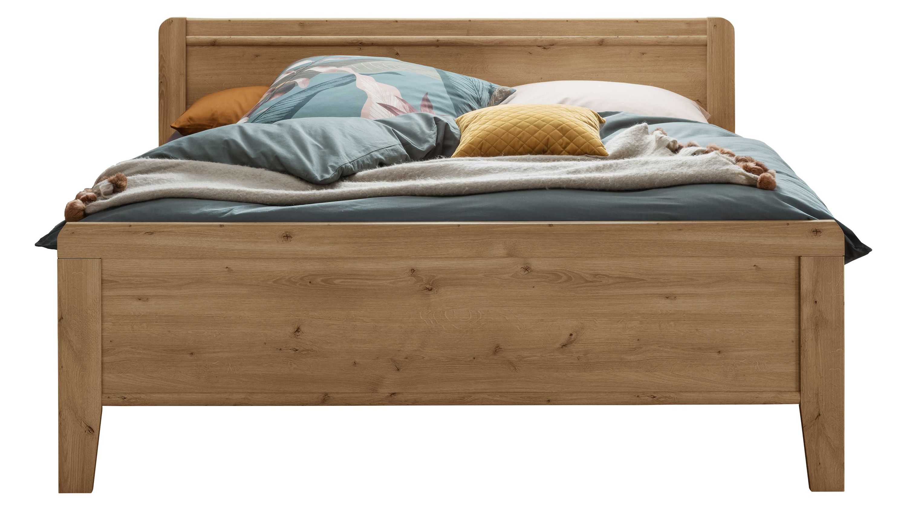 Doppelbettgestell aus Holz mit Kopf- und Fußteil in heller Eichenoptik mit Bettwäsche in Blau und Gelb